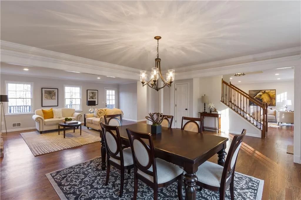 Whole-home remodel connecting dining and living areas with warm finishes and layered furnishings.